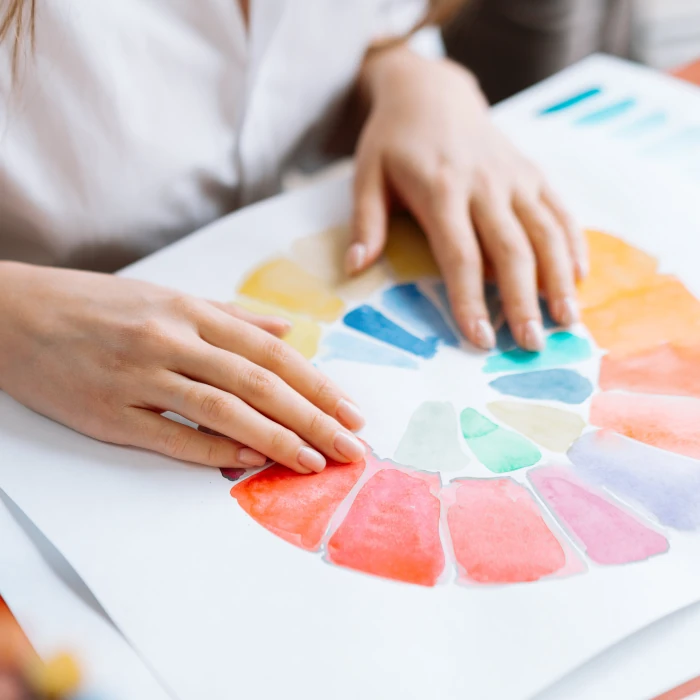 Student studying a colour wheel, as part of the course curriculum